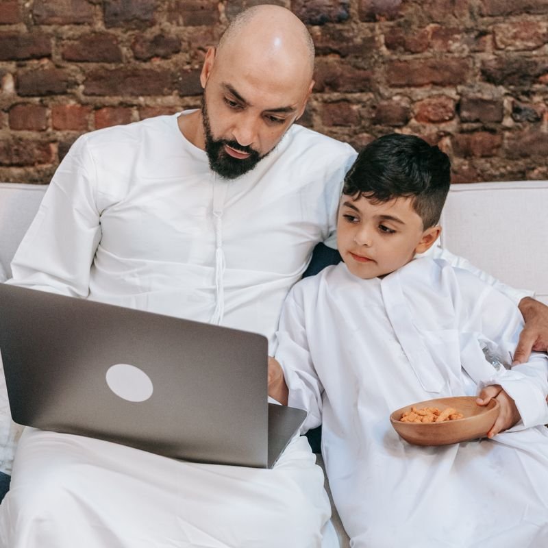 Father and son joining an online Quran lesson together